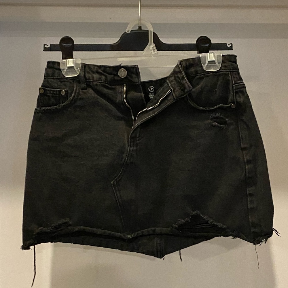 Distressed black denim skirt